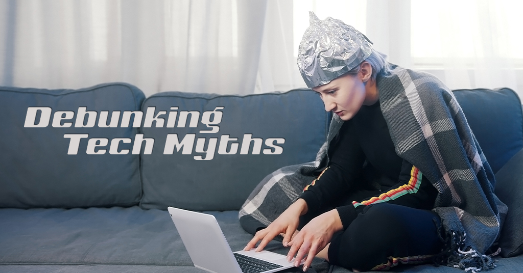 Debunking Tech Myths Part One - A woman wearing aluminum foil on her head on a laptop